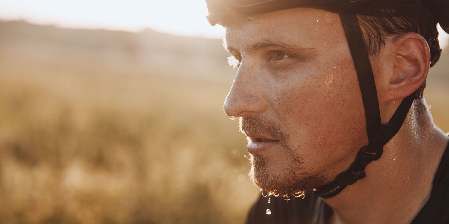 Sweaty man with bicycle helmet