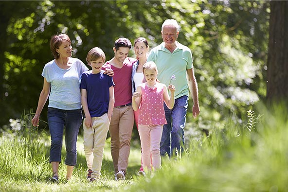 Happy family walking together in the forest