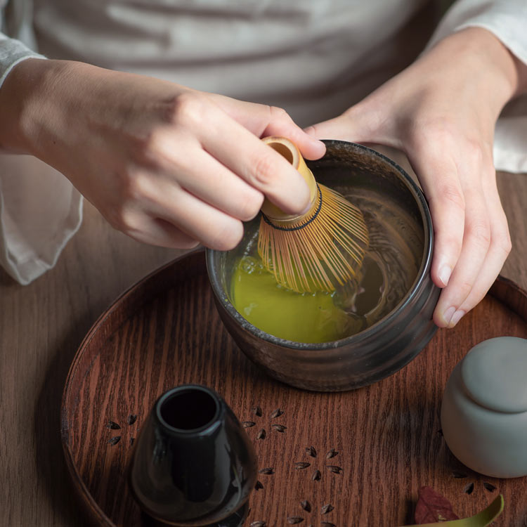 Traditional matcha tea is being made